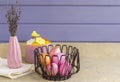 Happy easter. Painted pink eggs in a metal basket on a light background. Still life. Easter and spring holiday concept Royalty Free Stock Photo