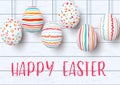 Happy Easter. pending easter eggs on white wooden background. Easter colorful hanging