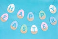 Happy Easter phrase made from wooden coloured eggs