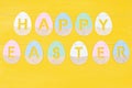 Happy Easter phrase made from wooden coloured eggs