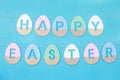 Happy Easter phrase made from wooden coloured eggs