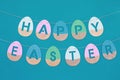 Happy Easter phrase made from wooden coloured eggs