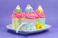 Happy Easter pink, yellow and blue cupcakes with cute chicken decorations