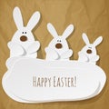Happy Easter Postcard threeBunnies on a crumpled paper brown background. Royalty Free Stock Photo