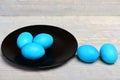 Traditional easter eggs painted in blue color on black plate Royalty Free Stock Photo
