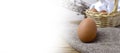 Happy Easter rustic background banner. Brown egg on sacking fabric over tradition festive composition.