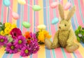 Happy Easter scene. Rabbit and bright colored flowers.