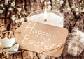 Happy Easter sign with egg shells and feather