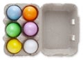 Happy Easter, six colorful eggs in box cardboard, top view isolated on white background. Copy space Template for advertising promo Royalty Free Stock Photo