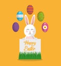 Happy easter smiling rabbit with poster and colored eggs Royalty Free Stock Photo