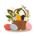 Happy Easter. Spring bouquet of flowers in a wicker basket with Easter colorful eggs Royalty Free Stock Photo