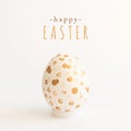 Happy Easter square greeting card with message and single handpainted egg with gold dots on white. Minimalistic background