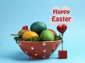 Happy Easter still life with rainbow color eggs against a blue background with sign