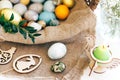 Happy Easter. Stylish Easter candle, eggs, easter bread cake, ham, beets, sausage, butter, green branches in wicker basket on Royalty Free Stock Photo