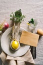 Happy Easter. Stylish easter eggs on a napkin with spring flowers on white wooden background