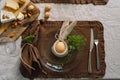 Happy Easter. Stylish easter eggs on a napkin with spring flowers on white wooden background