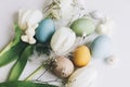 Happy Easter! Stylish Easter eggs and tulips on rustic white wooden background. Natural dyed colorful eggs, spring flowers, Royalty Free Stock Photo