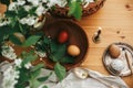 Happy Easter, Stylish Rural flat lay. Easter eggs with modern wax ornaments and natural dyed eggs on rustic wooden table with