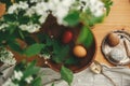 Happy Easter, Stylish Rural flat lay. Easter eggs with modern wax ornaments and natural dyed eggs on rustic wooden table with