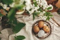 Happy Easter. Stylish Rural flat lay. Natural Easter eggs with modern wax ornaments on vintage plate on background of white spring