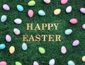 Happy Easter text surrounded with colorful Easter eggs on grass