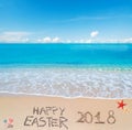 Happy easter 2018 on a tropical beach under clouds Royalty Free Stock Photo