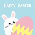 Happy Easter. White bunny rabbit holding big painted egg. Funny head face, eyes, ears. Cute kawaii cartoon character. Baby greetin Royalty Free Stock Photo