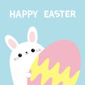 Happy Easter. White bunny rabbit holding big painted egg. Happy Easter. Funny head face, eyes, ears. Cute kawaii cartoon character Royalty Free Stock Photo