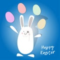Happy easter. White rabbit juggling easter eggs. Blue background.
