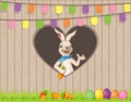 Happy Easter wishing you bunny with eggs carrots behind fence on hearth shape hole