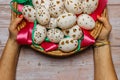 Happy Easter. Woman Hands holding basket with hand made decorated Easter eggs.Spring decoration background. Festive Royalty Free Stock Photo