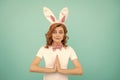 happy easter woman with rabbit ears on blue background. praying