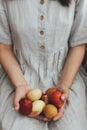 Happy Easter! Woman in rustic linen dress holding natural dyed easter eggs in hands. Aesthetic Royalty Free Stock Photo