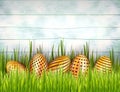 Happy Easter wooden background with bottom border from golden eggs and green grass. Royalty Free Stock Photo