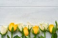 Happy Easter. Yellow and white roses on white wooden background. Easter background with copy space. Floral pattern. Greeting card Royalty Free Stock Photo