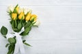 Happy Easter. Yellow and white roses on white wooden background. Easter background with copy space. Floral pattern. Greeting card Royalty Free Stock Photo