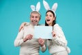 Happy easter for your company. Bunny: upset rabbit couple. Portrait of happy Easter bunny man and woman hold board paper Royalty Free Stock Photo