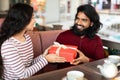 Happy eastern couple celebrating birthday or anniversary at coffee shop Royalty Free Stock Photo