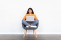 Happy eastern woman digital nomad working on laptop, copy space Royalty Free Stock Photo