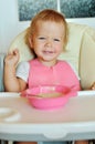 Happy eating baby girl Royalty Free Stock Photo