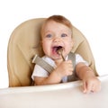 Happy eating baby in a high chair.