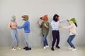 Happy eccentric young people with heads of various animals dance and have fun together. Royalty Free Stock Photo