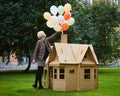 Happy educator playing with girl in playhouse in kindergarten Royalty Free Stock Photo