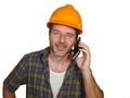 Happy efficient and cheerful workman or contractor man wearing builder hat tallking with satisfied customer on mobile phone Royalty Free Stock Photo