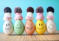 Happy eggs in hats laughing. Easter holiday concept with cute eggs with funny faces. Royalty Free Stock Photo