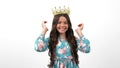 happy egocentric child in queen crown pointing thumb up on herself, egoistic