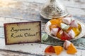 Happy Eid text in turkish on vintage table with sugar candies Royalty Free Stock Photo