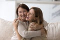 Happy elder mom embracing beautiful adult daughter woman with joy Royalty Free Stock Photo
