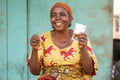 ahappy elderly african woman holding some money Royalty Free Stock Photo
