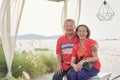 Happy elderly Asian couple relaxing by the sea, Happy Retirement concept, Travel for Chinese Lunar New Year holiday concept Royalty Free Stock Photo